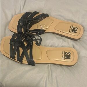 SM New York Black and Tan Sandals with Crisscross Straps. New